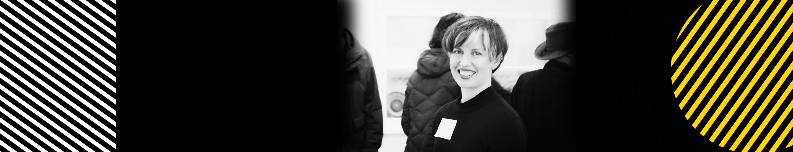 Black and white photo of short haired woman smiling.