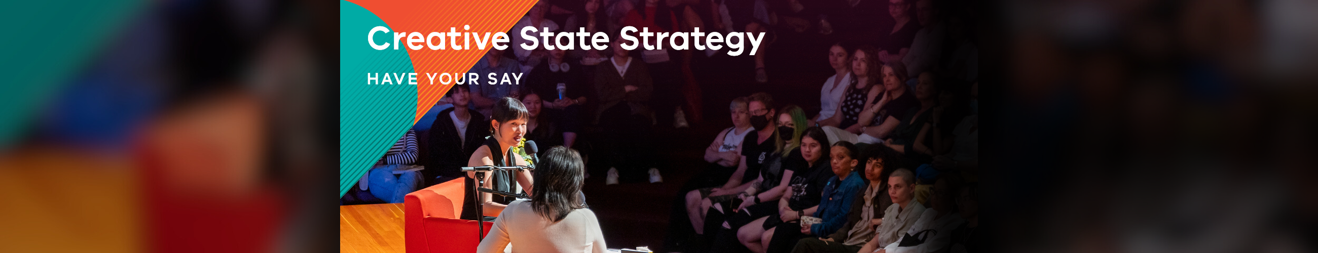 Text: Creative State Strategy, have your say. Photo of two people talking on stage with the audience looking on.