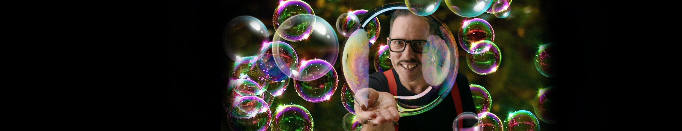 Man surrounded by large bubbles.