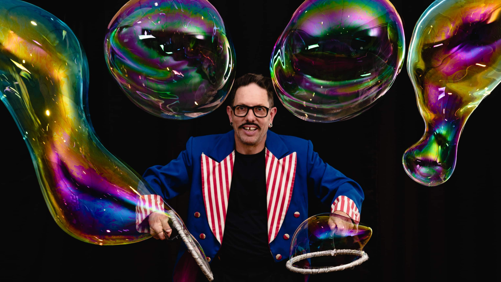 Man surrounded by large bubbles.